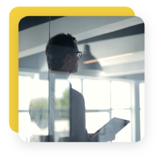 Sales leader conducting meeting in glass meeting room